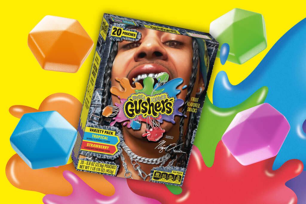 A Gushers Limited Edition Nigel Xavier Variety Pack, front of pack, on a yellow background with colorful splats behind it
